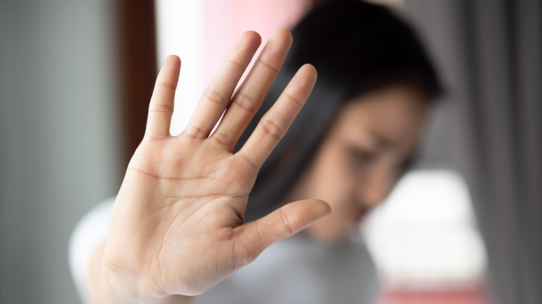 Woman putting her hand up