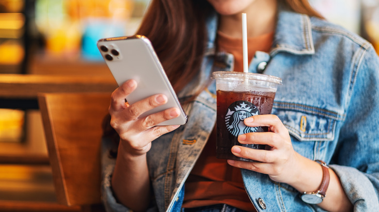 Woman with Starbucks and phone