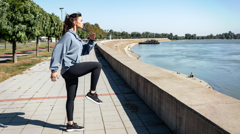 Woman performing high knee workout