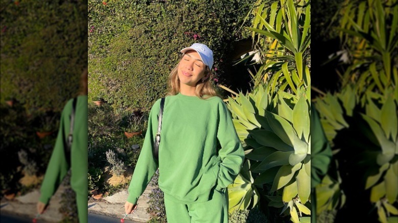 baseball cap with green athleisure outfit