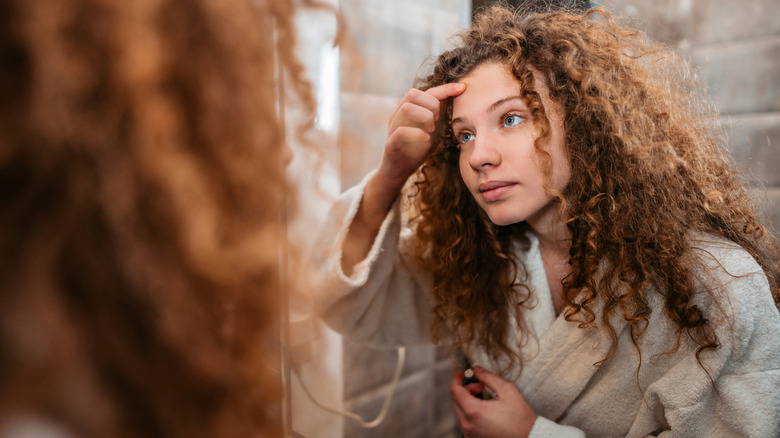 Woman looking in mirror