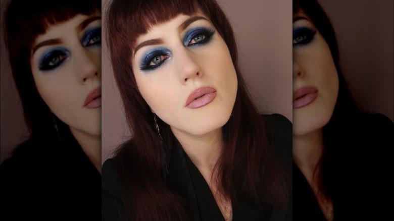 Women models makeup with smoky blue eye and light blue inner corner highlight 