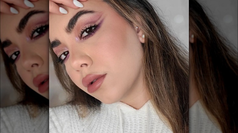 Young women models makeup with mauve inner corner highlight 