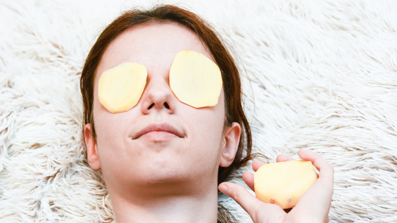 Girl using potato as skincare