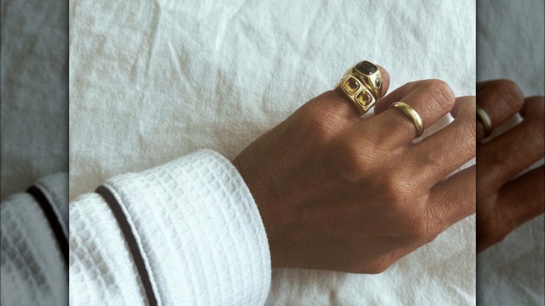 hand with pinky rings