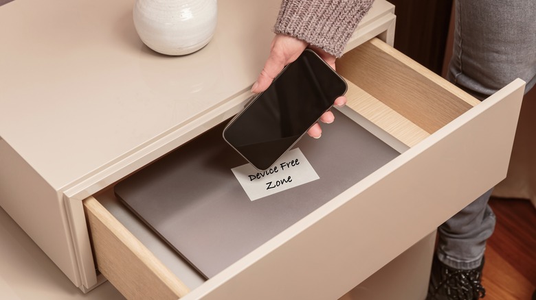 putting phone away in drawer