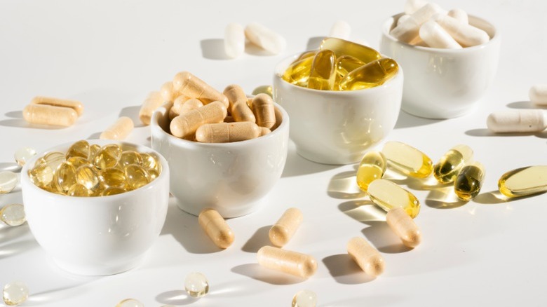 Cups of supplements on table