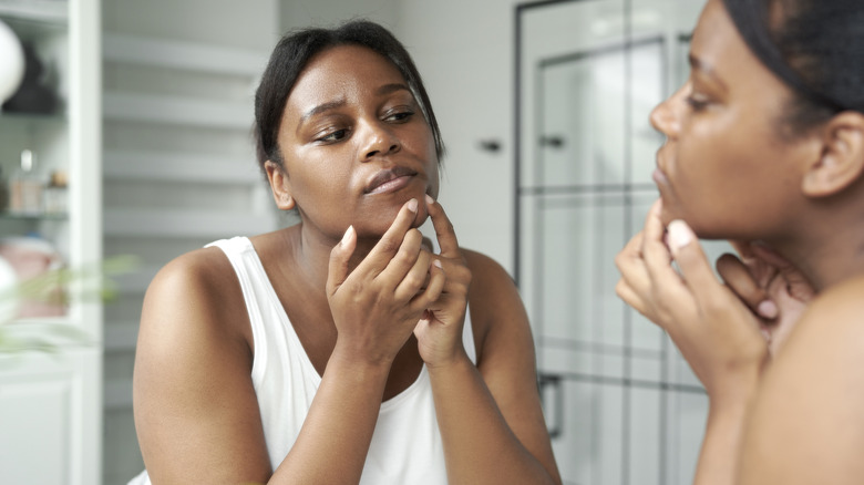 Woman popping pimple