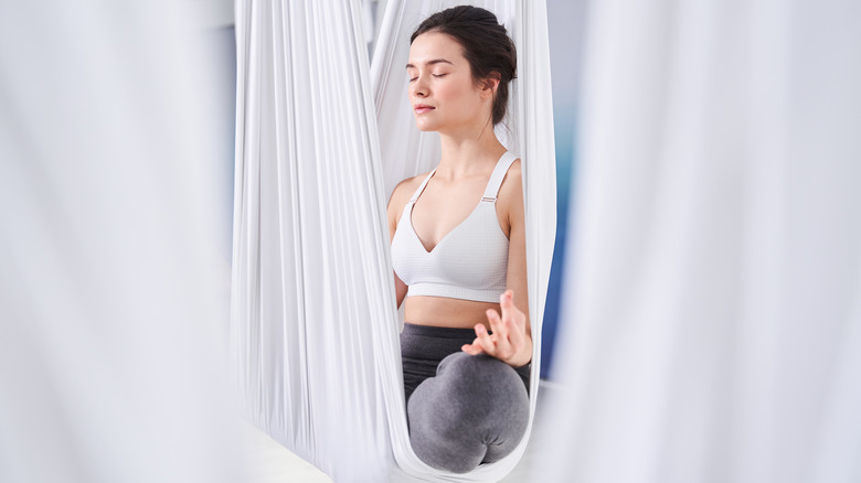 Woman meditating aerial yoga