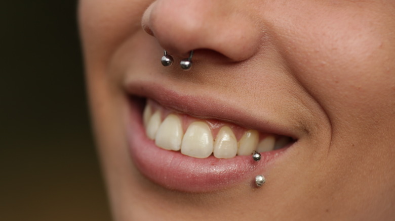Person smiling with lip piercing