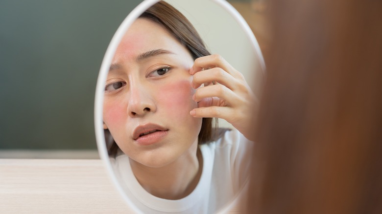 woman looking at irritated skin