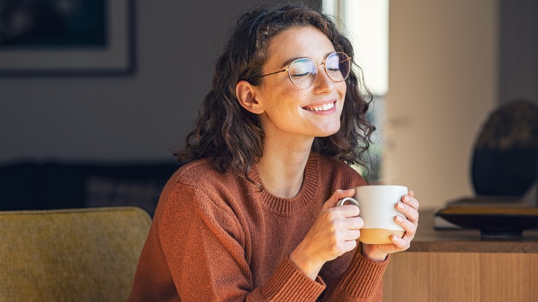 Woman enjoys a warm drink