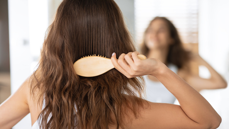 Woman brushing hair smooth
