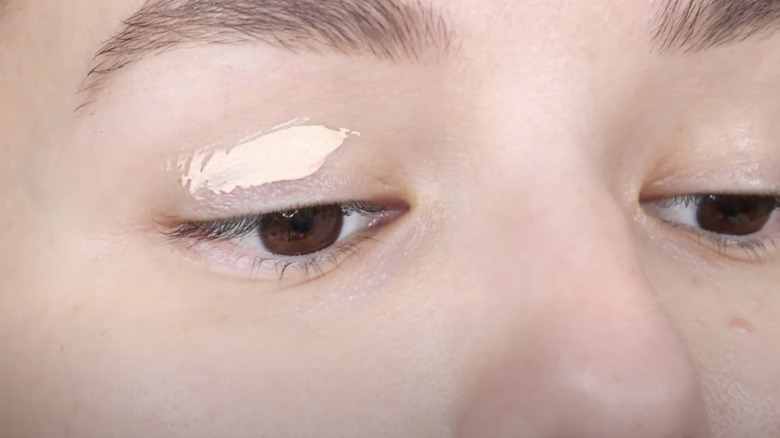 Woman applying eyeshadow primer