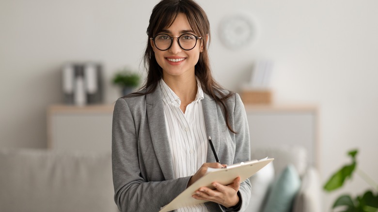 Smiling therapist with clipboard 