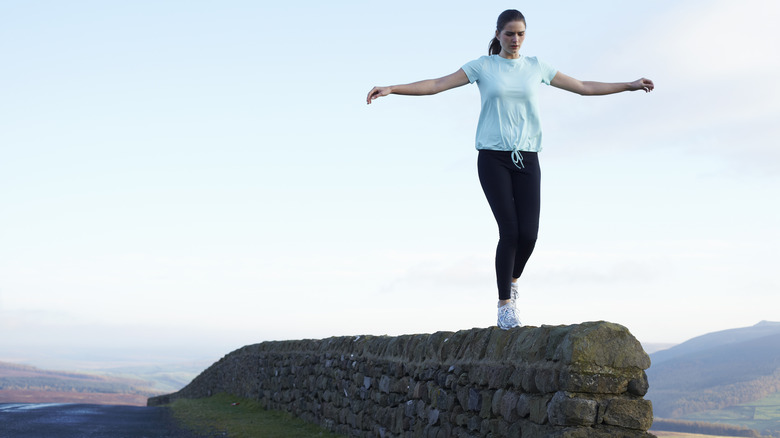 woman balancing on a rock