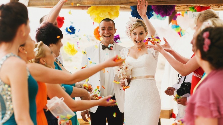 Wedding guests cheering for couple