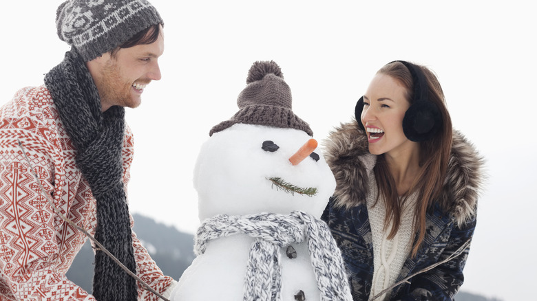 couple building a snowman