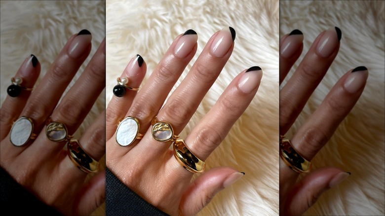 Black asymmetrical French tip nail art