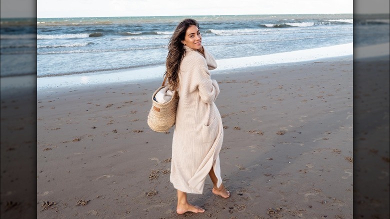 woman on beach wearing long cardigan