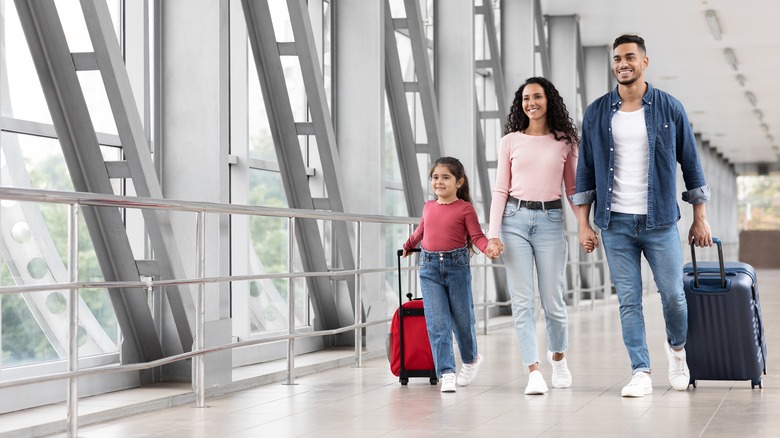 Family walks through airport