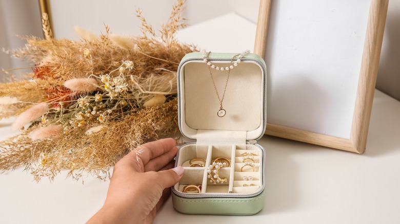 close up of jewelry inside a small jewelry box on a table