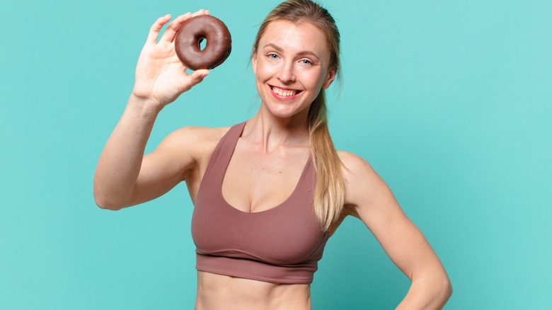 woman holding a donut