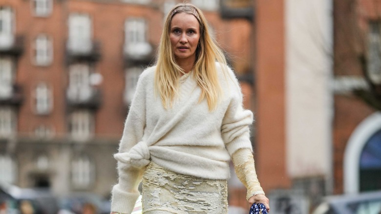 woman wearing knotted sweater