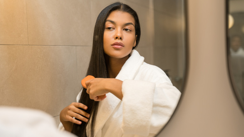 woman brushing long hair