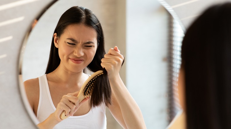 woman brushing tangled hair