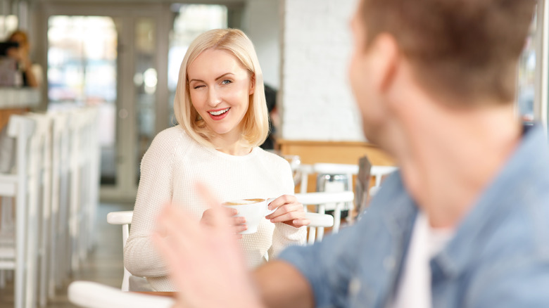 Woman winks at potential mate