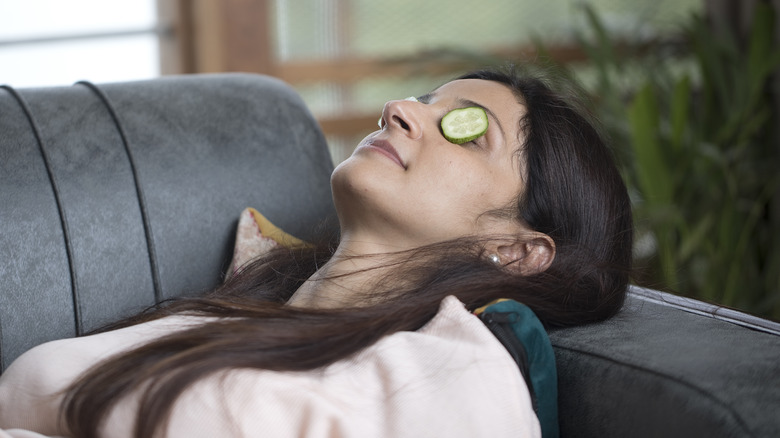 Woman resting with cucumber slices