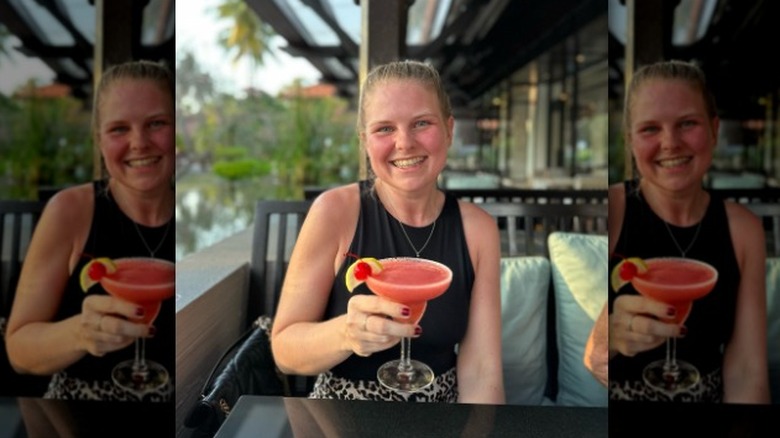 Woman holding pink cocktail