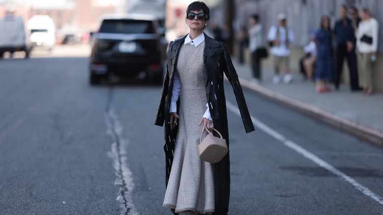 woman wearing maxi dress and coat