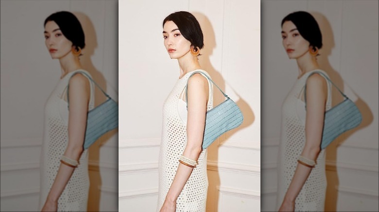 model with blue shoulder bag