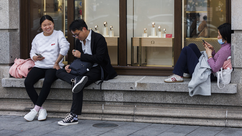 People sitting outside a store