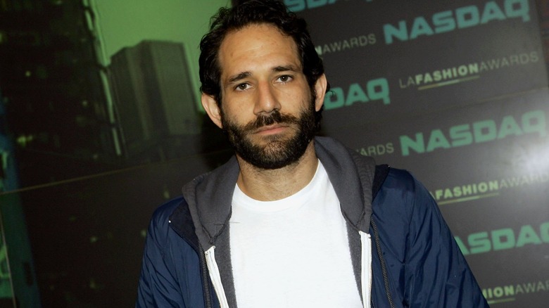 Dov Charney standing without smiling