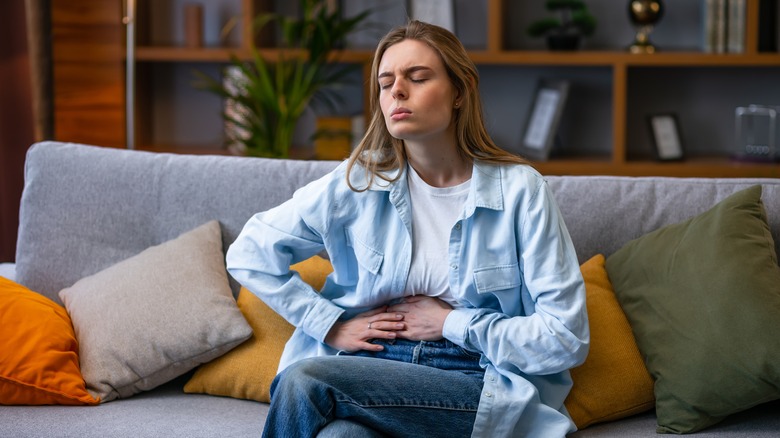 woman holding stomach 