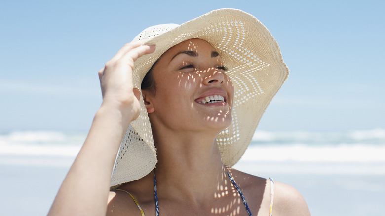 woman on beach with hat