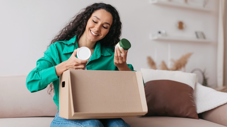 Woman unpacking products from box