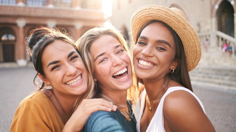 Three friends smiling