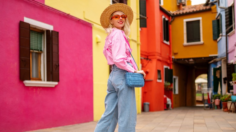 Woman wearing pink shirt and blue jeans