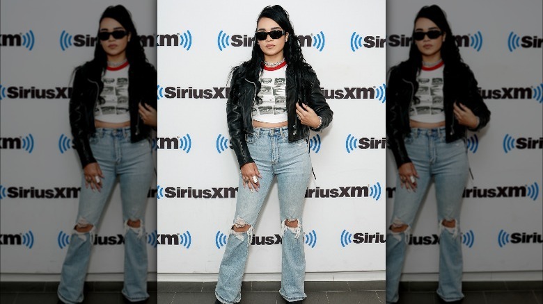 Woman wearing distressed bootcut jeans 