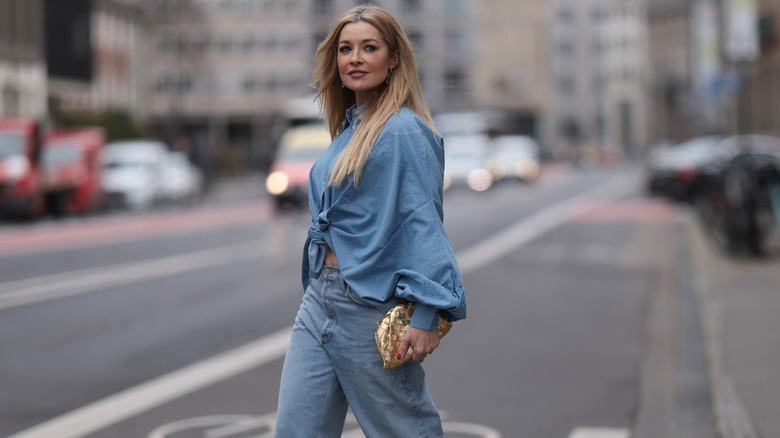 Woman wearing denim shirt and jeans