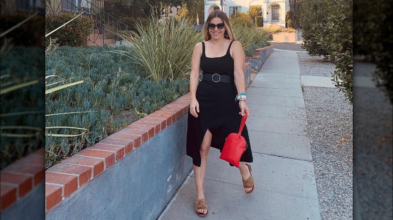 Woman wears belted black sundress 