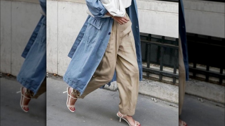 denim trench coat and khaki trousers