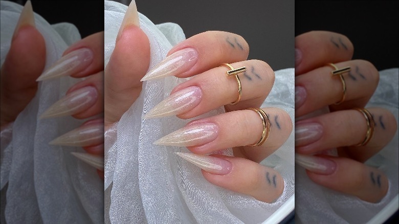 Woman wearing sharp angel nails