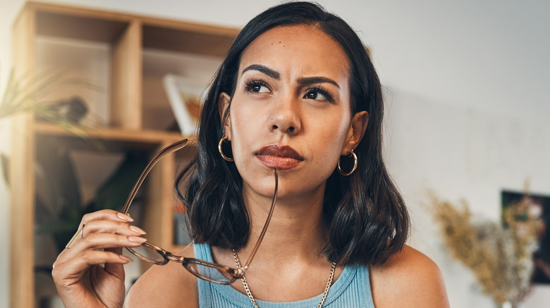 woman thinking with glasses