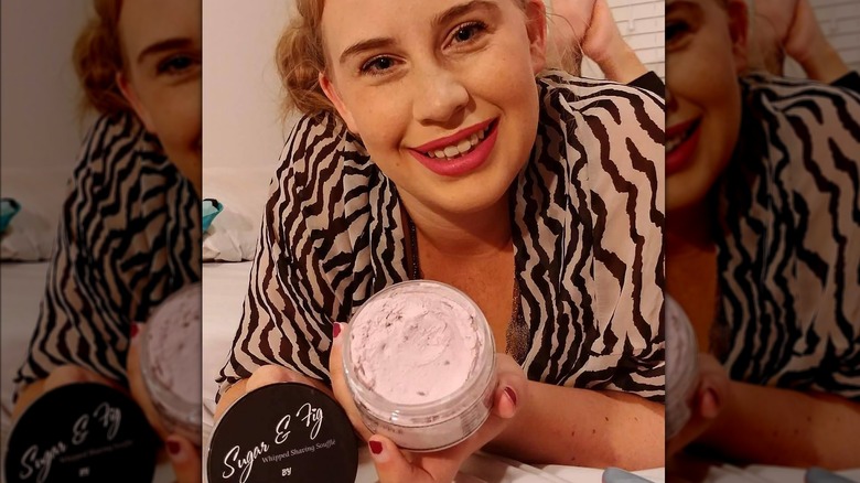 Customer poses with Angel Shave Club skincare product 
