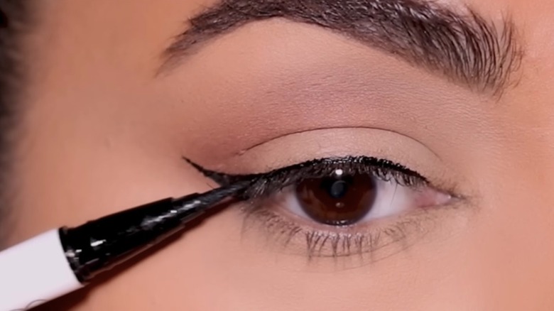 woman creating eyeliner